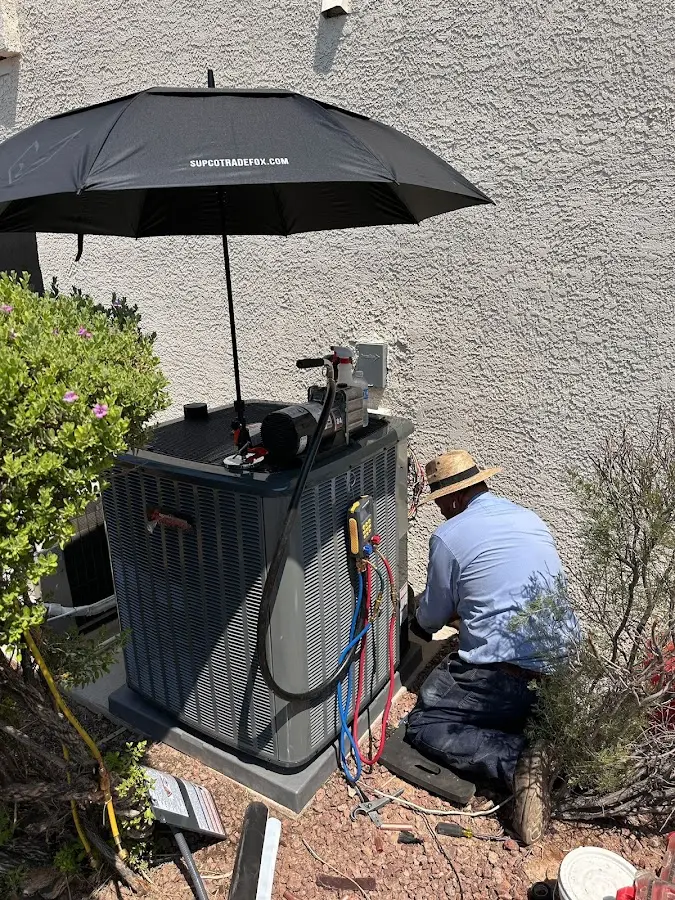 HVAC technician performing outdoor AC maintenance in East Hanover